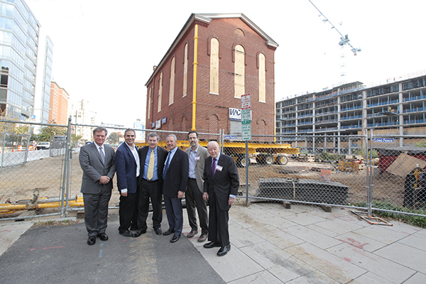 Stuart Zuckerman, Adam Rubinson, Howard Morse, Albert H. Small, Jr., Ernie Marcus, and Albert H. Small pose in front of the historic synagogue at the 2016 moving of the synagogue.