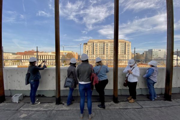 Museum staff look out over the city from the rooftop during a site visit, December 2021.