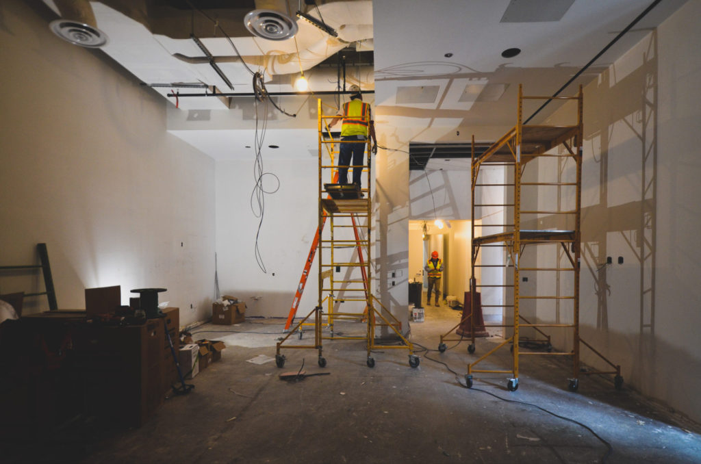In the galleries, workers hanging drywall for the ceiling, Apr 2022