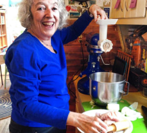 An older white, Jewish woman preparing gefilte fish in the kitchen.